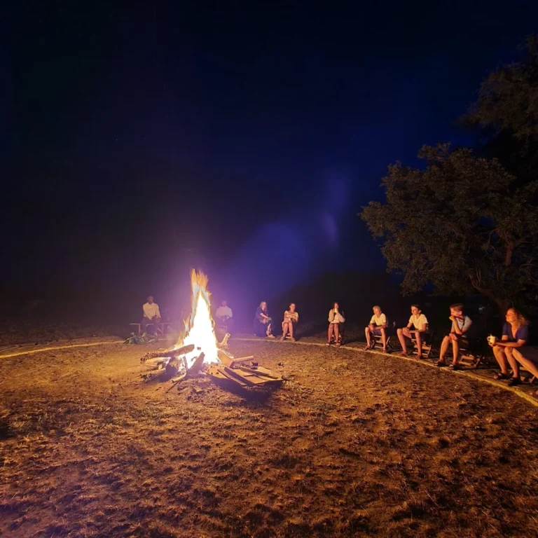 Guest enjoying story time around the camp fire at Alakara guest house, karamoja, Uganda